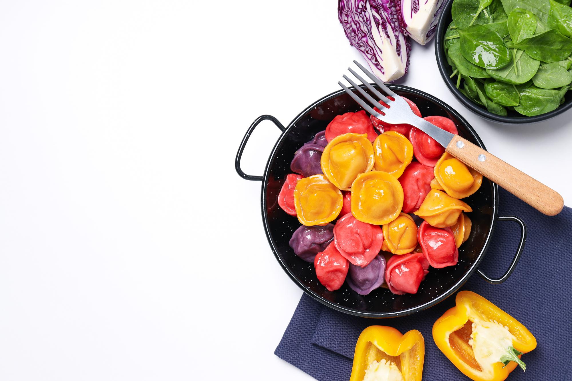 Stove with colourful pan and vegetables